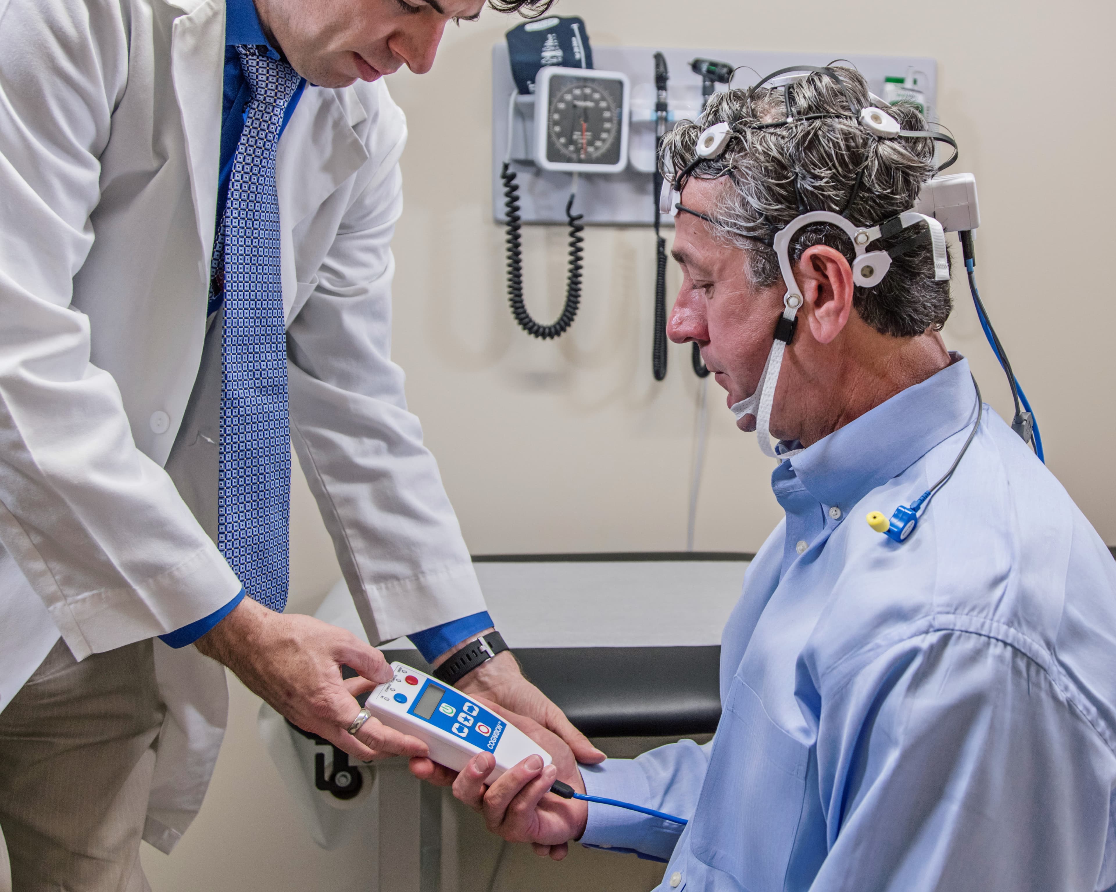 Physician administering an EEG / ERP cognitive assessment