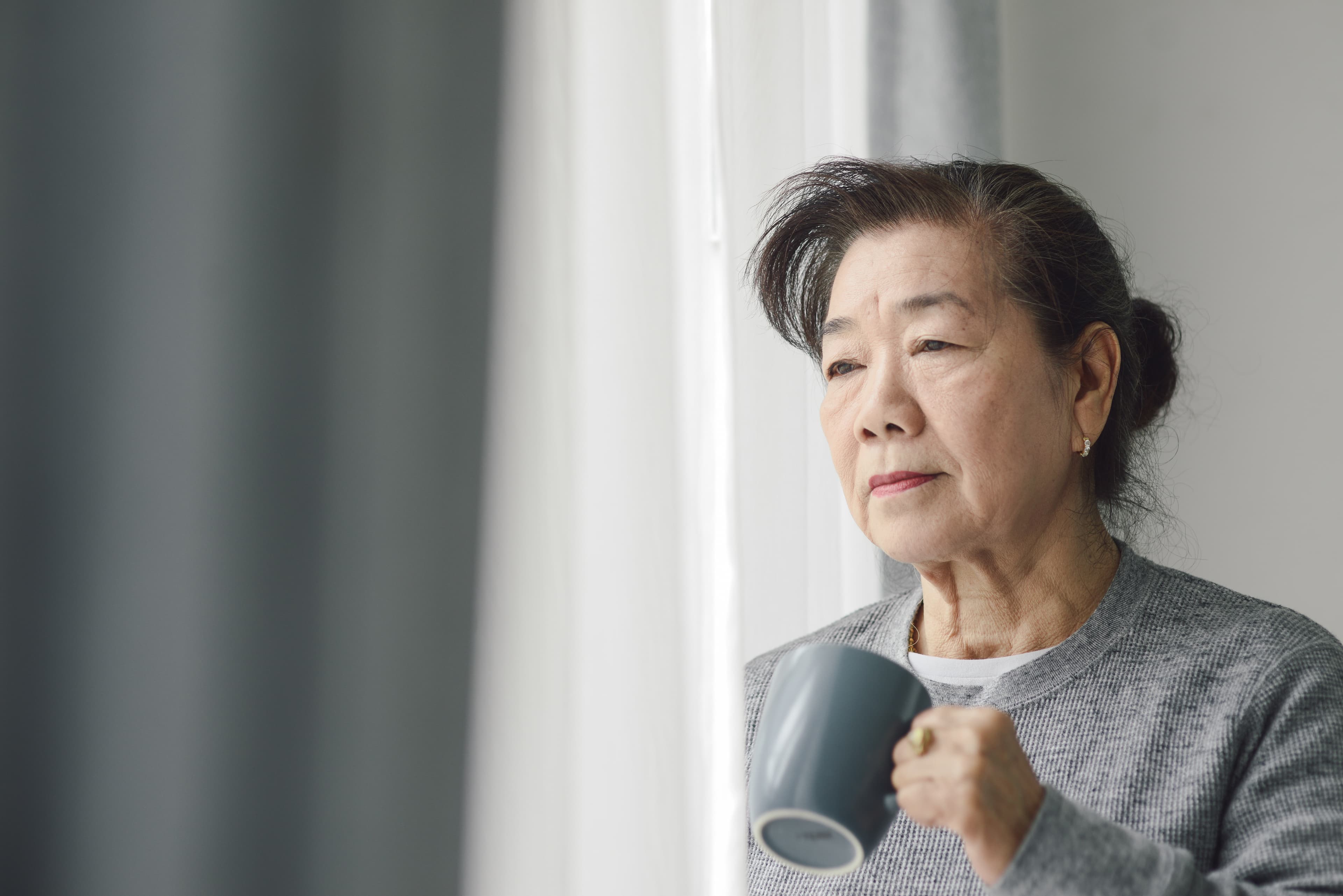Older adult at home, calm, window light (flyer cover)